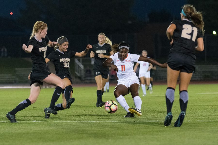 Illinois' Patricia George passes through defenders during the game against Purdue at Illnois Soccer Stadium on Thursday, September 15. The Illini lost 0-2.