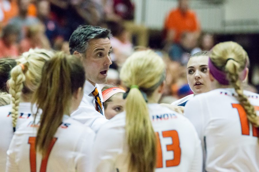 Illinois head coach Kevin Hambly talks to his team between sets during the match against Arkansas on August 26. The Ilini won 3-0.
