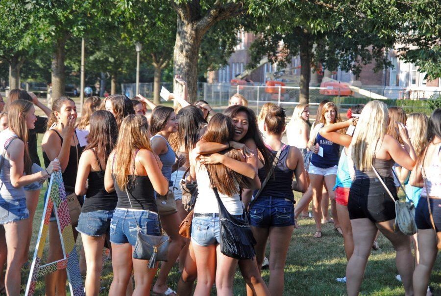 The new 2013 Alpha Chi Omega pledge class meets their sorority sisters after receiving their bid cards on bid day on the Quad.