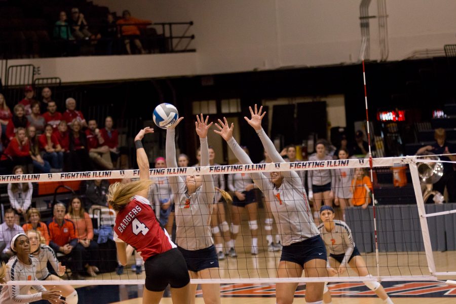 Illinois Ali Bastianelli and Jocelynn Birks attempt to block a Wisconsin hit during the match against Wisconsin at Huff Hall on Wednesday, Nov. 18, 2015. Illinois lost 3-2.