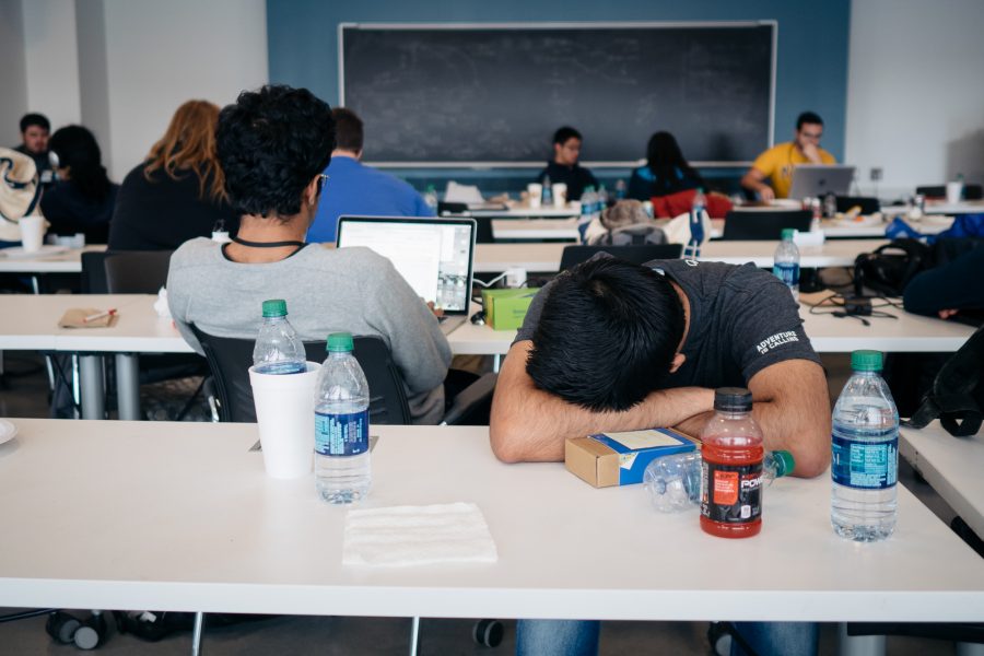 A student sleeps in the classroom of the Electrical and Computer Engineering building.