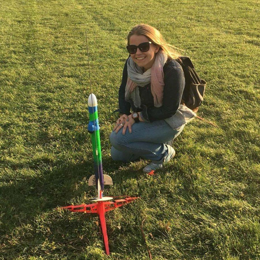 Gianna Ciaglia, freshman in aerospace engineering, poses with a rocket she built in her Aerospace 100 course.