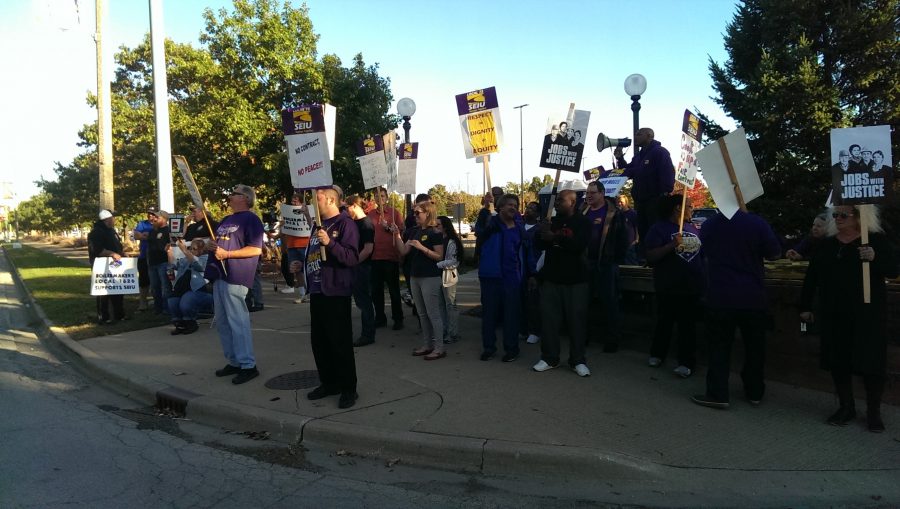 Aaron Ammons, right, with megaphone, leads members of the Service Employees International Union Local 73 during the third picket of the year. 