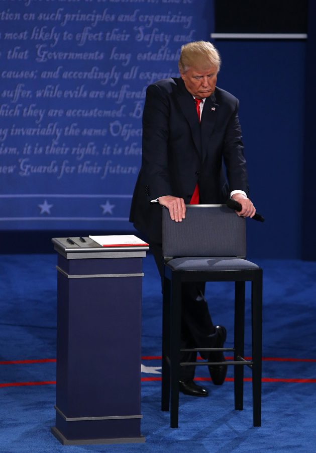 Donald Trump listens during the second debate between the Republican and Democratic presidential candidates on Sunday, Oct. 9, 2016 at Washington University in St. Louis, Mo. 