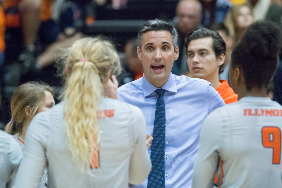 Illinois head coach Kevin Hambly talks to his team during a timeout in the match against Northwestern at Huff Hall on Saturday, October 15. The Illini won 3-0.