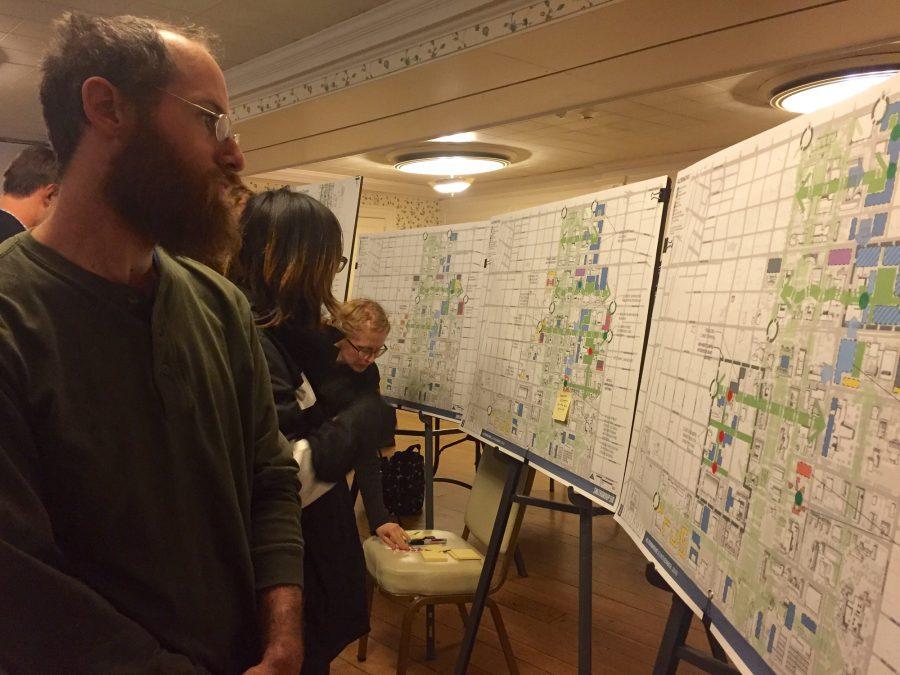 Jacob Benjamin, manager of the campus bike center, views one plan proposed for the campus master plan at a forum Wednesday night at the Illini Union. 