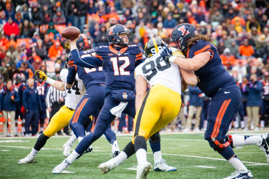 Illinois+quarterback+Wes+Lunt+%2812%29+throws+a+pass+during+the+first+half+of+the+game+against+Iowa+at+Memorial+Stadium+on+Saturday%2C+November+19.+The+Illini+are+losing+7-0+at+halftime.