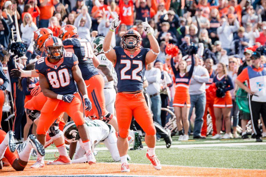 Illinois running back Kendrick Foster (22) celebrates after scoring a touchdown during the first half of game against Michigan State at Memorial Stadium on Saturday, November 5. The Illini lead 7-6 at halftime.