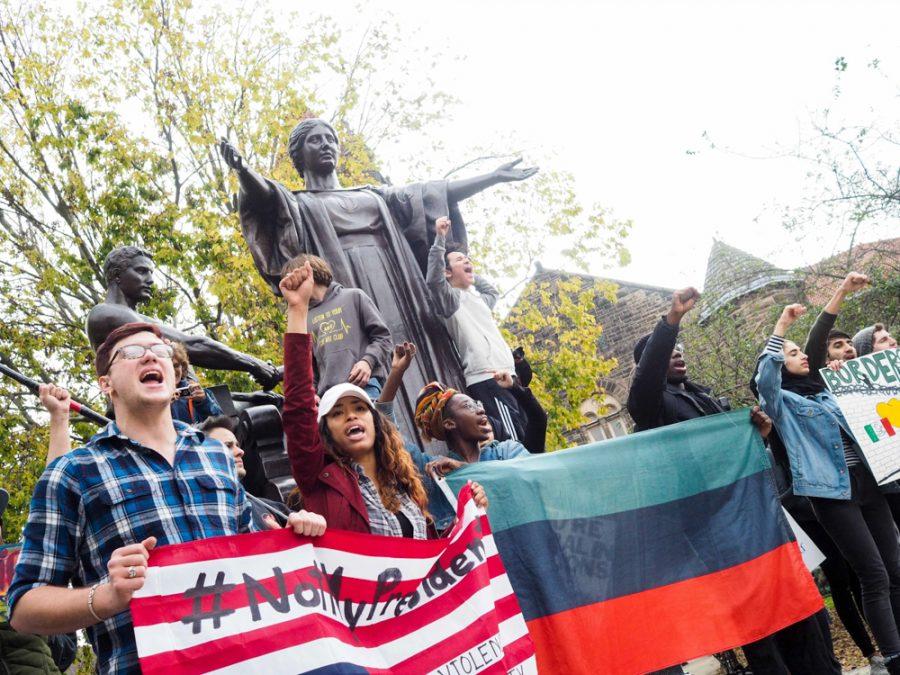 Students gather at Alma Mater to march through the Quad and down Green Street in order to protest President Elect Donald Trump on Friday.