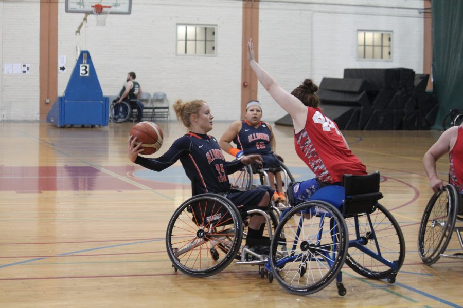 Grad student and captain Shelby Gruss looks to pass over threw the hands of the Mary Free Bed Rollin Drive defenders. Rollin Drive went on to defeat the Illinois womens wheelchair basketball team in the first round of the 2nd City Showdowns tournament in Chicago from Nov. 12-13.