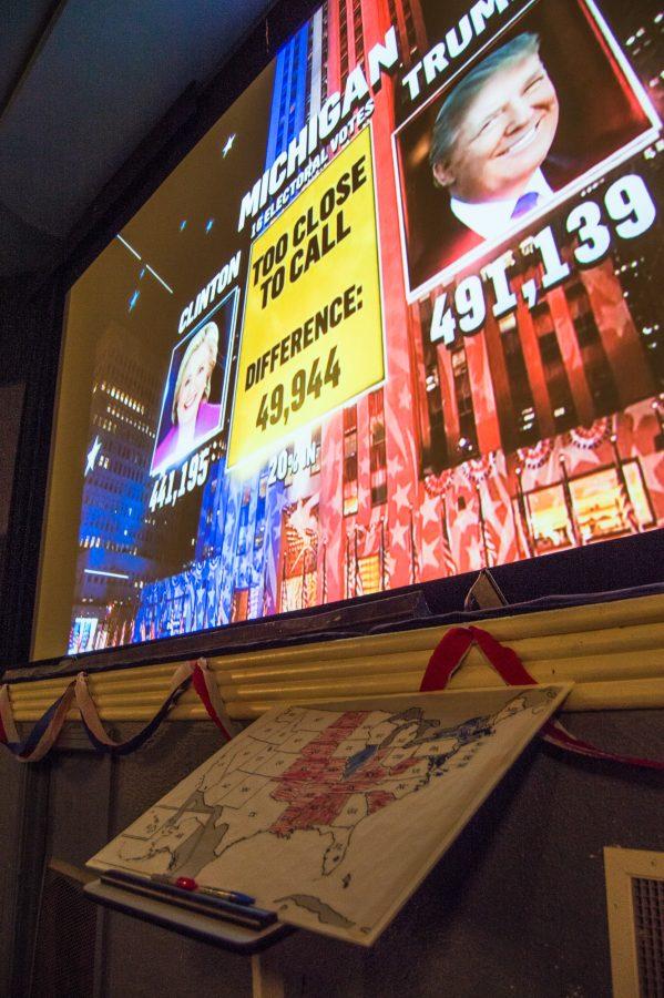 The 2016 election updates are projected on the screen at the Art Theater on Tuesday, November 8, 2016.