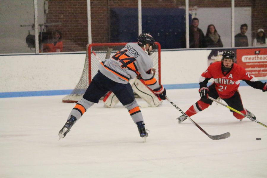 Eric Saulters (44) reaches for the puck to try and score against Northern Illinois at the Ice Arena on Friday, Dec. 2, 2016. Illini beat Northern 5-4.