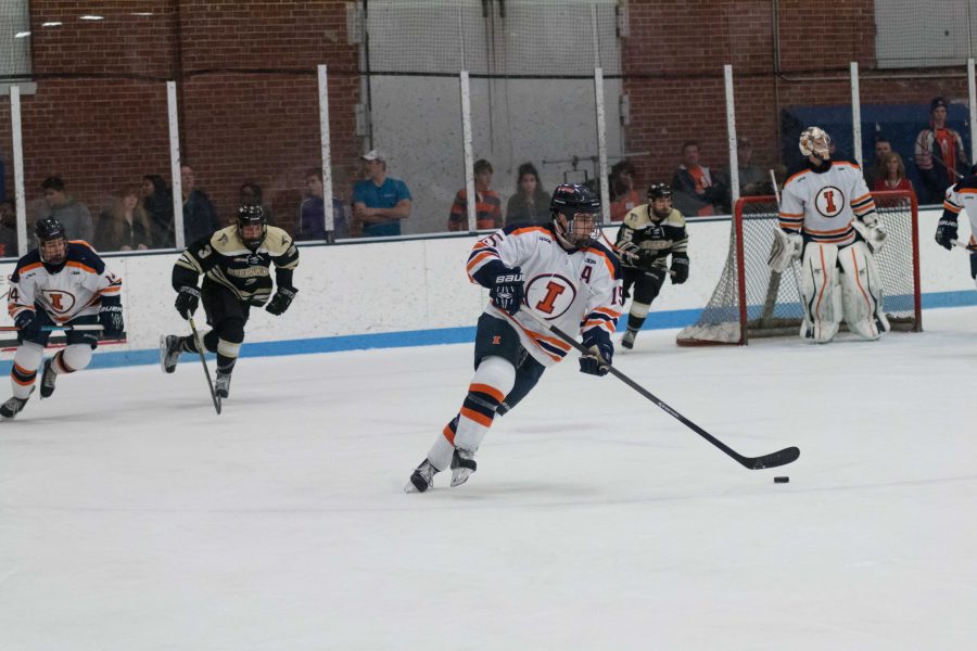 Illinois Eric Cruickshank carries the puck up the ice during the game against Lindenwold University at the Ice Arena on Saturday, January 30. The Illini lost 4-1.