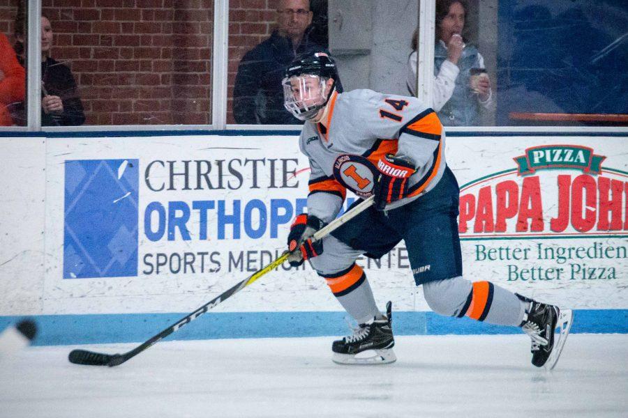 Illinois Chris Lozinak (14) carries the puck up the ice during the game against Robert Morris at the Ice Arena on Saturday, Feb. 18. 