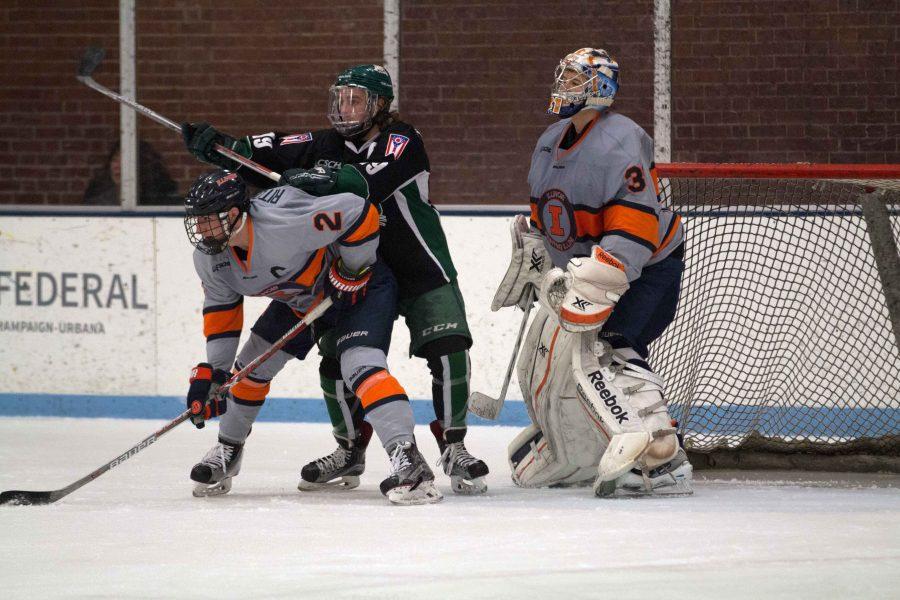 Joey Ritondale (2) fights off Ohios forward at the Ice Arena on Saturday. The Illini fell to Ohio, 4-1.