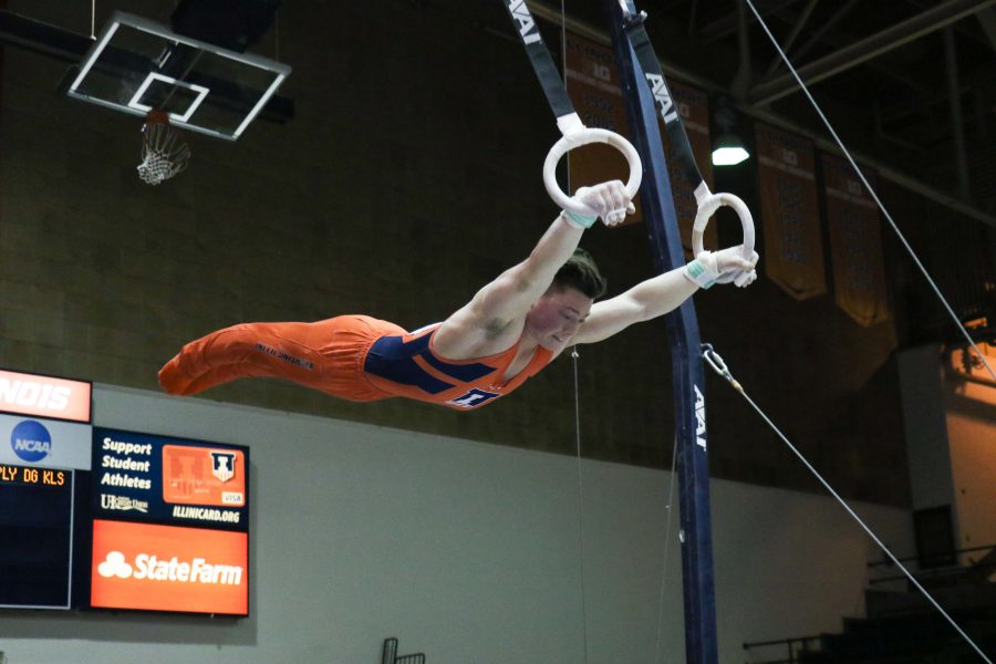 Illinois’ Alex Diab works the still rings at the meet against Minnesota in Huff Hall Saturday. His score tied the season high.