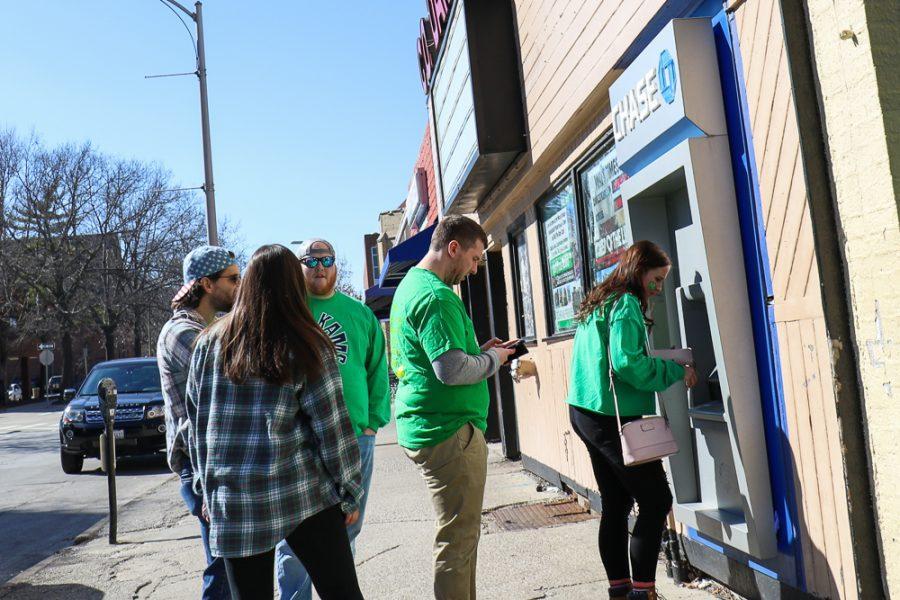 A line forms for the ATM on Daniel St. during Unofficial.