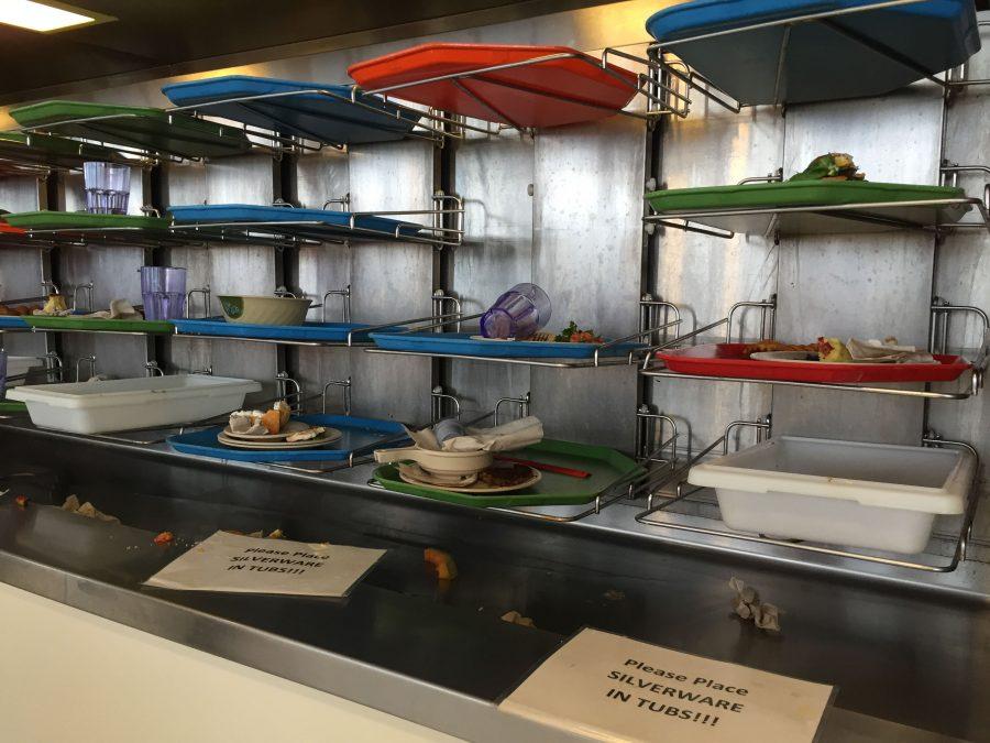Students put their food waste, along with their plates and utensils, on a moving tray conveyor belt in the Ikenberry Dinning Hall.