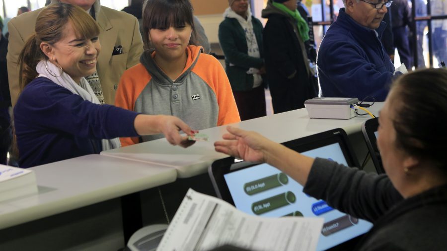 Sonia Sorino, left, with daughter Kelya, 12, right, was first in line to fill out paperwork for her California driver license at DMV offices on Friday, Jan. 2, 2015 in Granada Hills, Calif. (Brian van der Brug/Los Angeles Times/TNS)