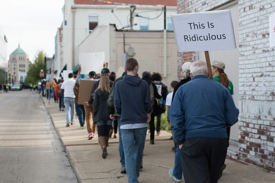 Champaign-Urbana community members march in downtown Champaign near the Orpheum Children’s Museum as part of the March for Science. In response to Saturday’s nationwide protests, Columnist Matt Silich believes scientists should be trusted to do their jobs.