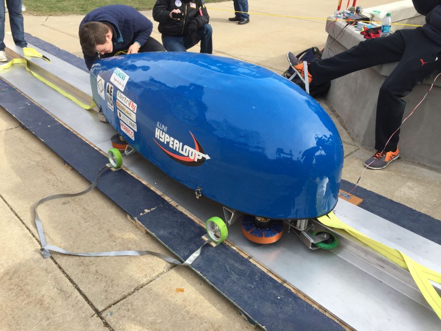 Illini Hyperloop members with the original pod they created for SpaceXs hyperloop competition. The team will be competing in the next SpaceX hyperloop competition later this year. 