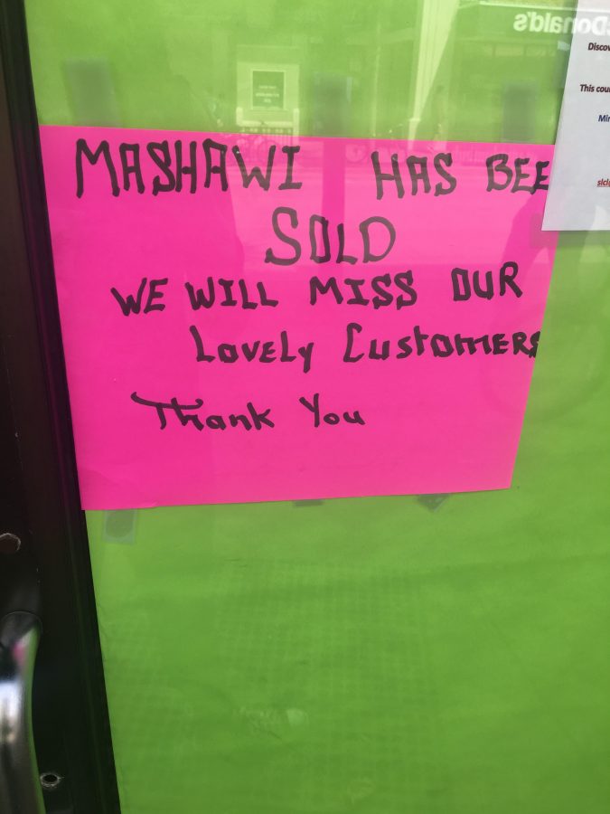 Sign outside Masawi Grill states permanent closing. 