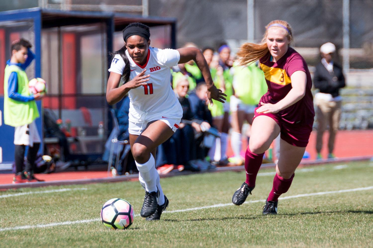 Illinois Patricia George (11) carries the ball up the field during the game against Loyola at the Illinois Soccer Stadium on Saturday, April 1. The Illini won 2-1.