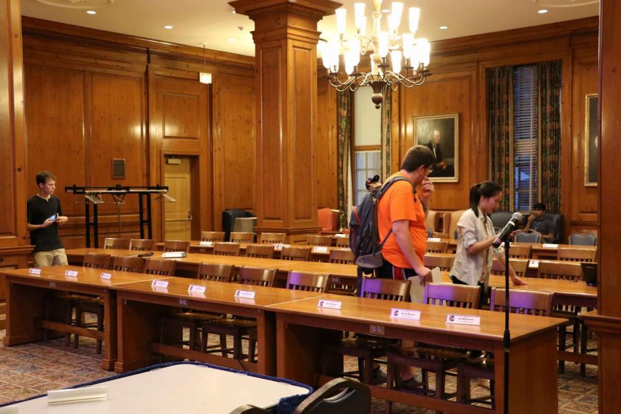 Students setting up name plates for each student senator prior to the meeting.