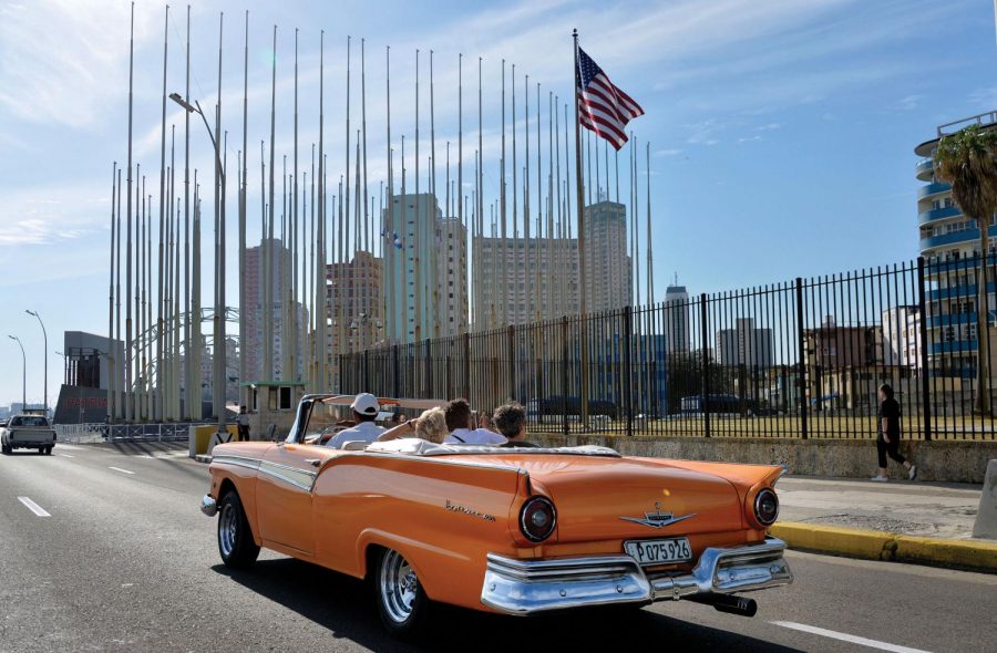 An old car passes in front of the U.S Embassy in Havana, Cuba, on March 17, 2016 prior to a visit by U.S. President Barack Obama.