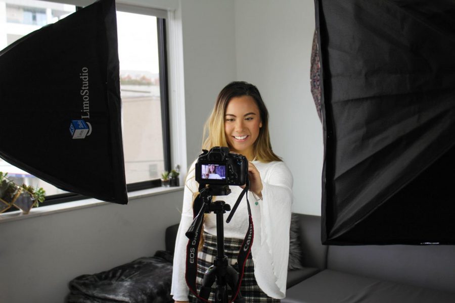 YouTuber Tiffany Nguyen setting up to record a video. Most of her videos are filmed in the comfort of her own apartment.
