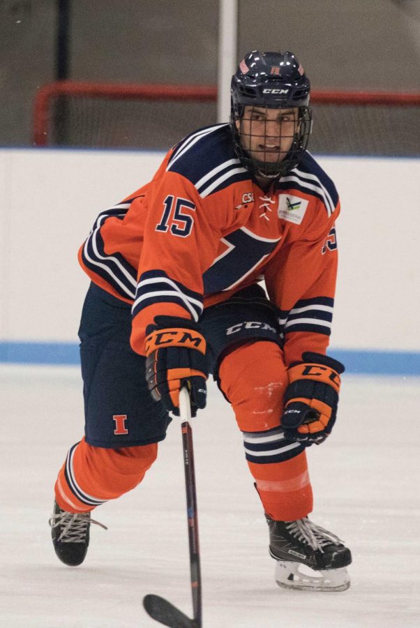 Eric+Cruickshank+%2815%29+reaches+for+the+puck+to+gain+possession+from+Michigan+State+at+the+Ice+Arena+on+Friday%2C+Sept.+22.+Illini+beat+MSU+4-1.+