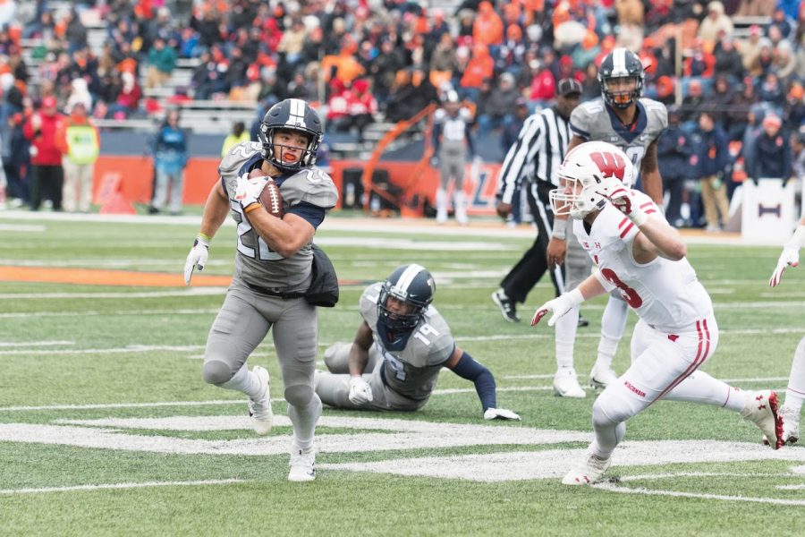 Illinois running back Kendrick Foster weaves around the defense during the game against Wisconsin on Saturday, Oct 28. The Illini lost 10-24.