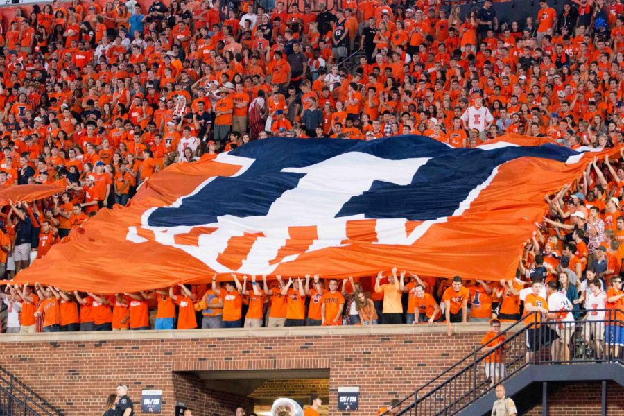 Students in Block I hold up the Illini shield flag during the game against North Carolina at Memorial Stadium on Sept. 10, 2016. Allie Hartlein, Block I communication chair, said students will perform an alumni-designed card stunt at the Homecoming football game on Saturday.