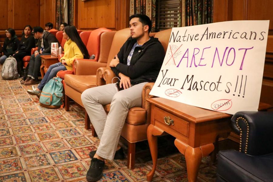 A student sits in on the Illinois Student Government meeting in the Illini Union Pine Room on Wednesday, Oct. 25. The Chief will make an appearance in the Homecoming Parade, so Illinois Student Government is boycotting the parade in support of Native American students.