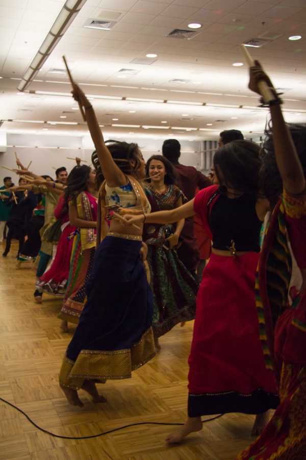 Students+dance+at+the+ISA+Garba+Raas+Bhangra+Cultural+Event+at+the+ARC+on+Saturday.+Students+performed+Raas%2C+a+traditional+Indian+folk+dance+that+is+done+in+pairs+while+holding+sticks+called+dandia.