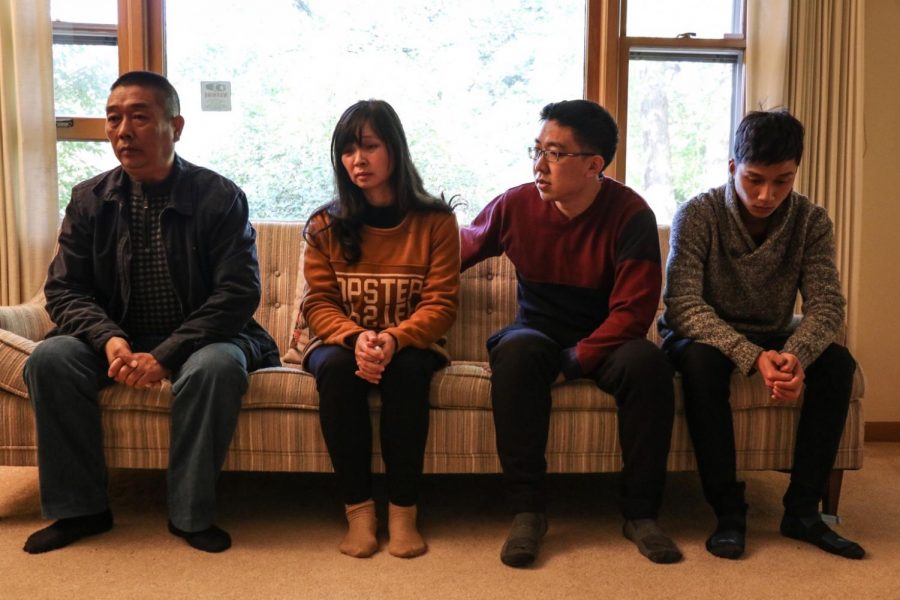 From left to right: Ronggao Zhang (Yingying’s father), Lifeng Ye (Yingying’s mother), Xiaolin Hou (Yingying’s boyfriend) and Xinyang Zhang (Yingying’s brother) sit in their rented Urbana home on Thursday.