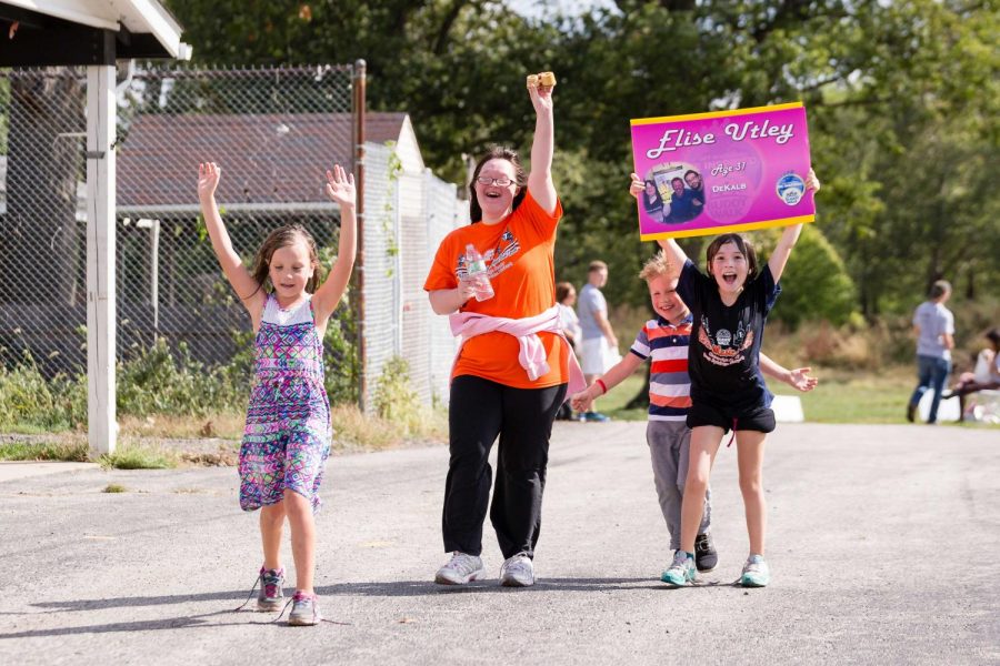 Elise Utley (orange) and her friends participate in the National Down Syndrome Society Buddy Walk at the Champaign County Fair Grounds on Saturday, October 7.