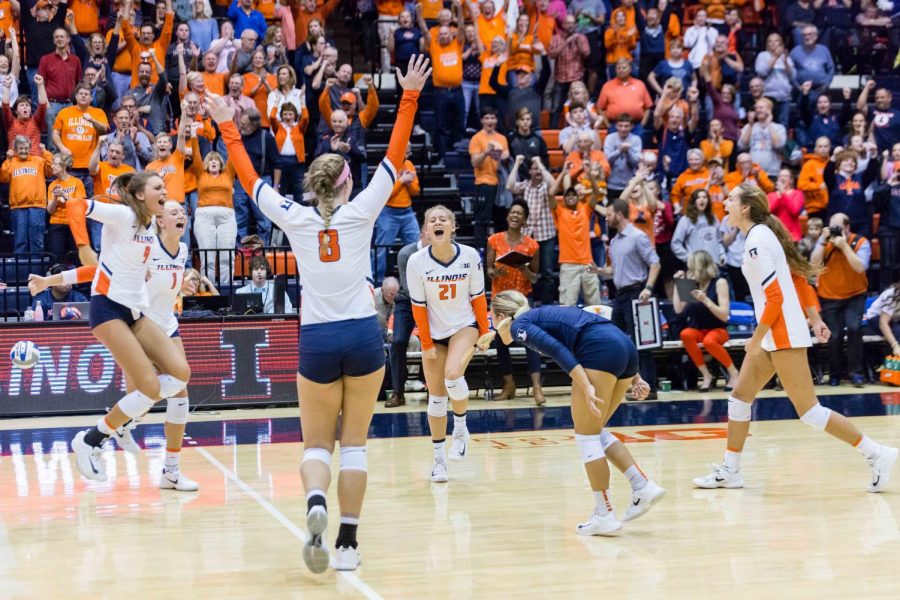 The Illini celebrate after scoring a point during the match against Michigan at Huff Hall on Saturday, Nov. 5, 2017. The Illini won 3-2.