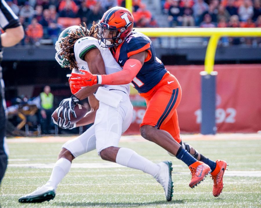 Illinois linebacker Tré Watson (33) makes a tackle during the game against Michigan State at Memorial Stadium on Saturday, November 5. The Illini won 31-27.