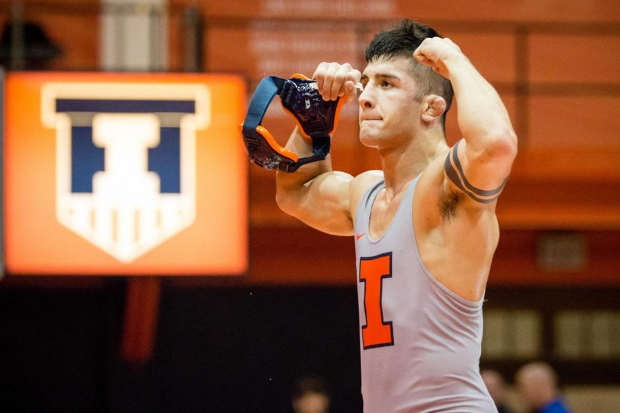 Illinois Isaiah Martinez celebrates after defeating Michigans Logan Massa in the 165-pound weight class during the match at Huff Hall on Jan. 20. Martinez won by decision and the Illini defeated the Wolverines 34-6.