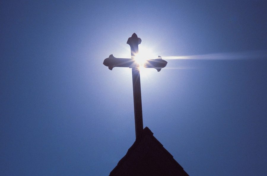 Silhouette of a cross on the roof of a church, Greece