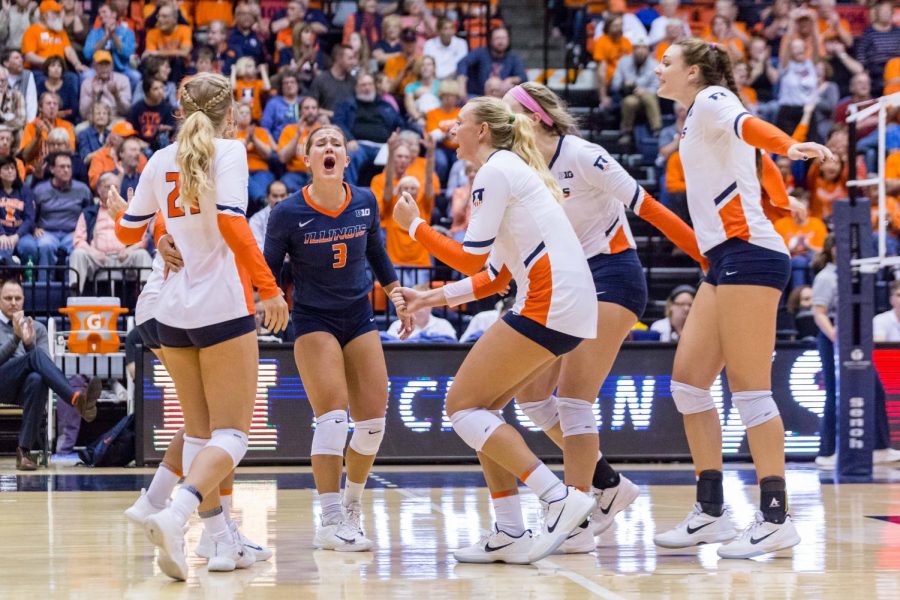 The Illini celebrate after scoring a point during the match against Michigan at Huff Hall on Saturday, Nov. 5, 2017. The Illini won 3-2.