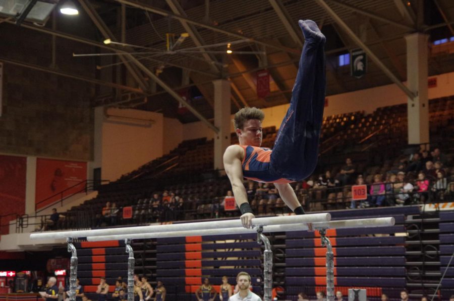 Illinois’ Bobby Baker performs his routine at the meet against Michigan on March 12, 2016. Baker has received many awards throughout his career, including Co-Gynmast of the Week.