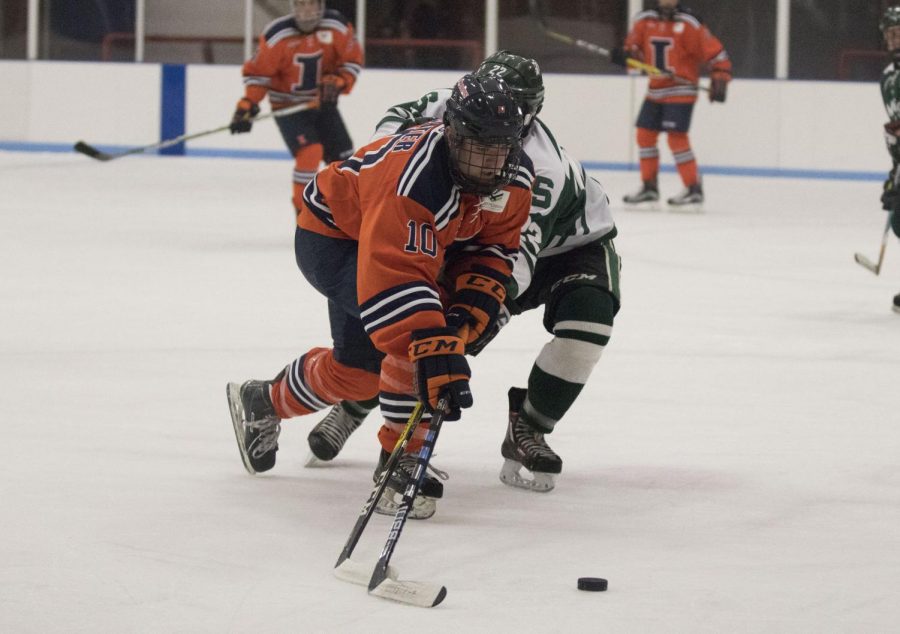 Drew Richter (10) fights off a Michigan State opponent to take the puck to the goal at the Ice Arena on Friday, Sept. 22, 2017. Illini beat MSU 4-1. 
