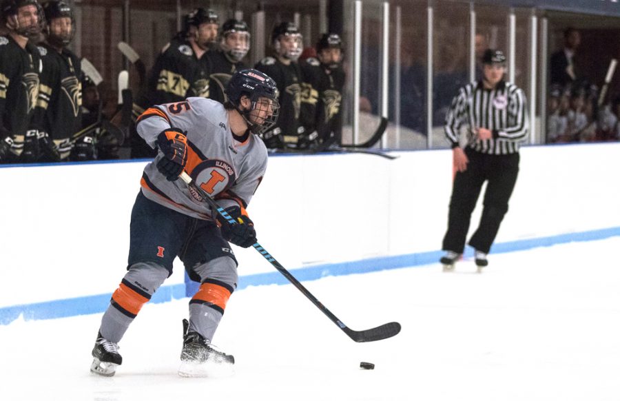 Eric Cruickshank (15) passes to a lineman across the ice past Lindenwoods players at the Ice Arena on Friday, Dec. 1.  Illini won in overtime 2-1.