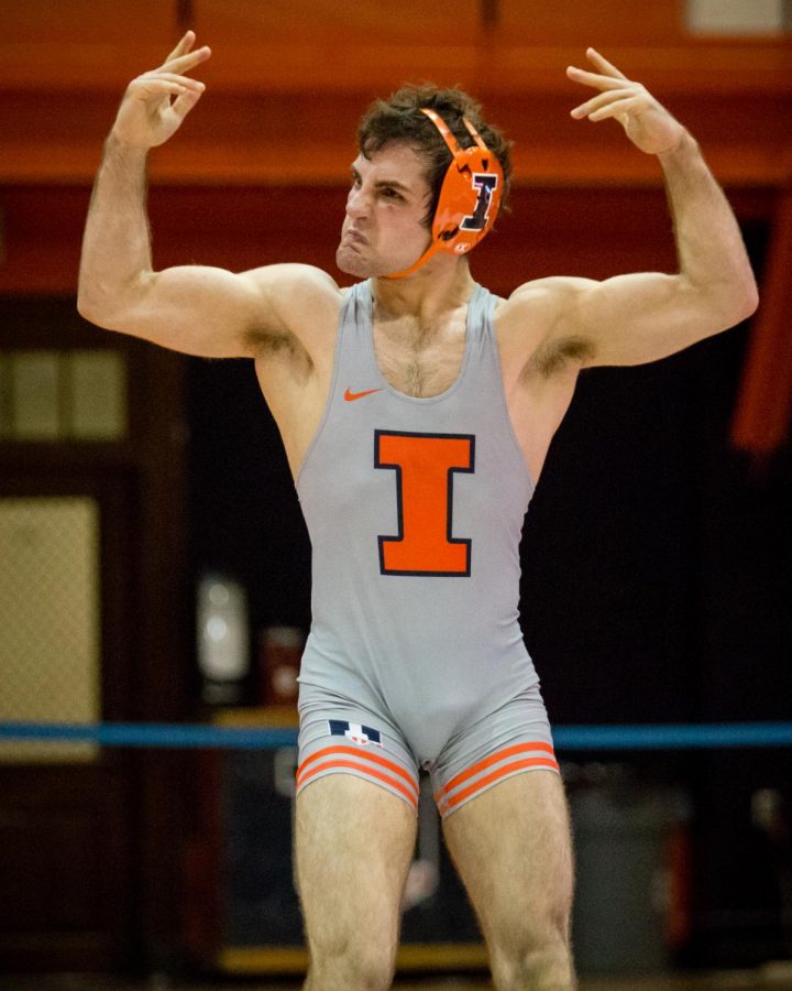 Illinois Zane Richards celebrates after defeating Michigans Stevan Micic in the 133 pound weight class during the match at Huff Hall on Friday, January 20. Richards won by decision and the Illini defeated the Wolverines 34-6.