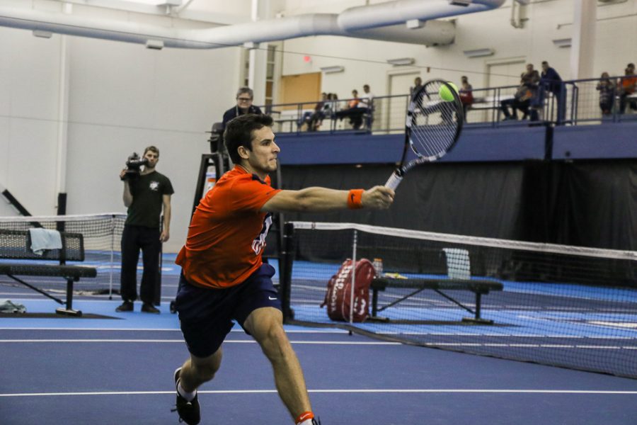 Illinois  Aleks Vukic strikes back the ball in the meet against University of Kentucky on Friday, Feb. 24 at the Atkins Tennis Center in Urbana.