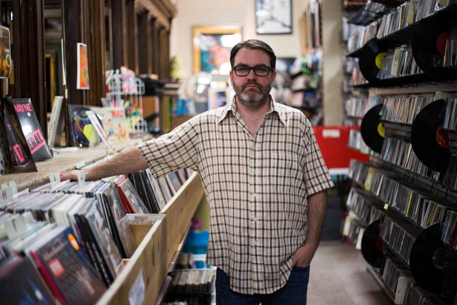 Jeff Brandt stands in his record store, Exile on Main, in downtown Champaign on Feb. 13, 2018. The store opened in November 2004, and moved to its current location ten years later.