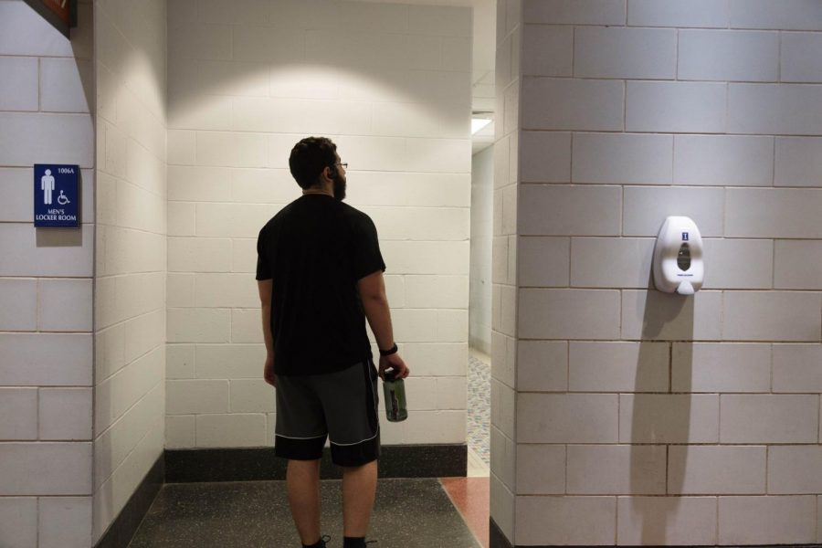 Luis Jaime walks into the mens locker room at Campus Recreation Center East on Feb. 23. 