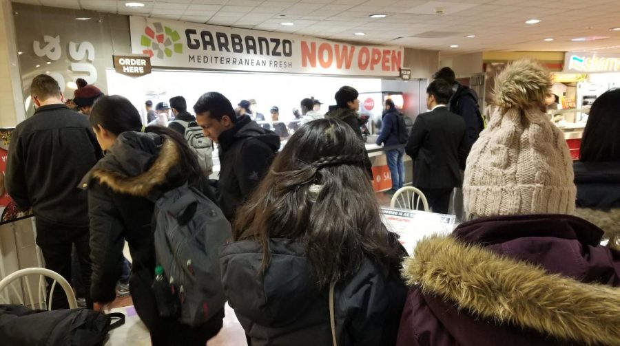People stand in line at Garbanzo in the basement of the Illini Union. The restaurant opened Thursday.